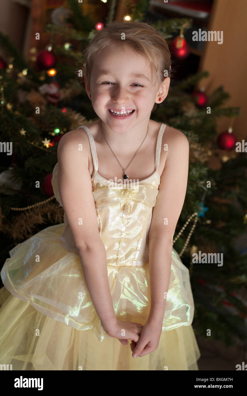 Little girl in a princess costume next to a Christmas tree. Stock Photo