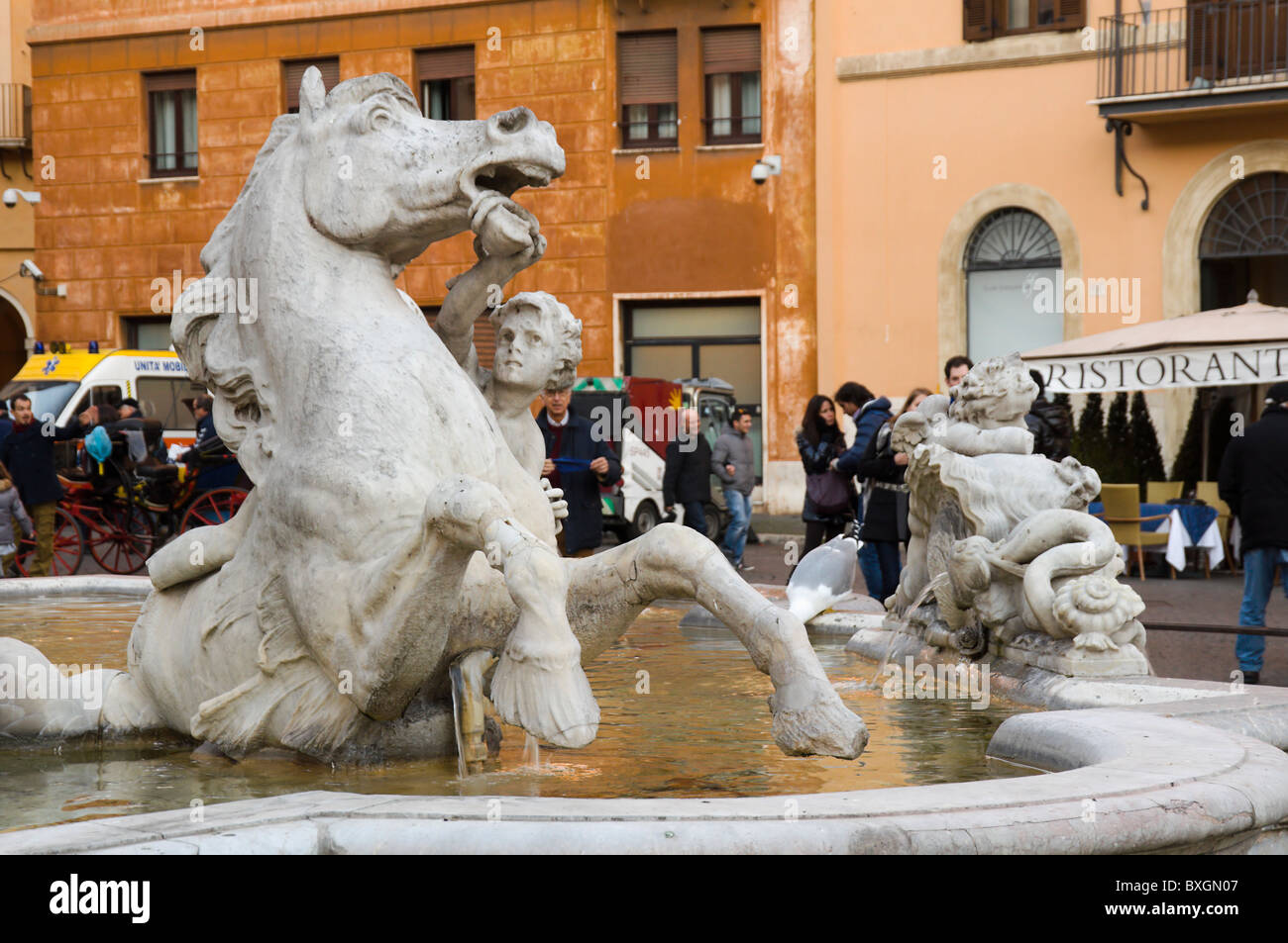 Rome, piazza Navona, fontana del Nettuno detail with Christmas market passerbies Stock Photo