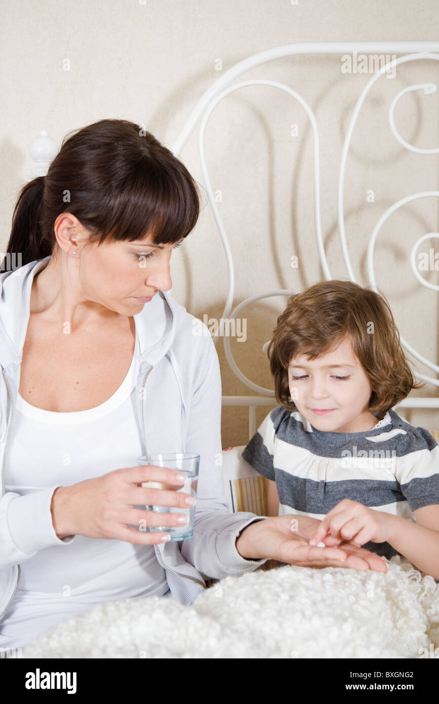 Mother giving a medicine to her daughter Stock Photo Alamy