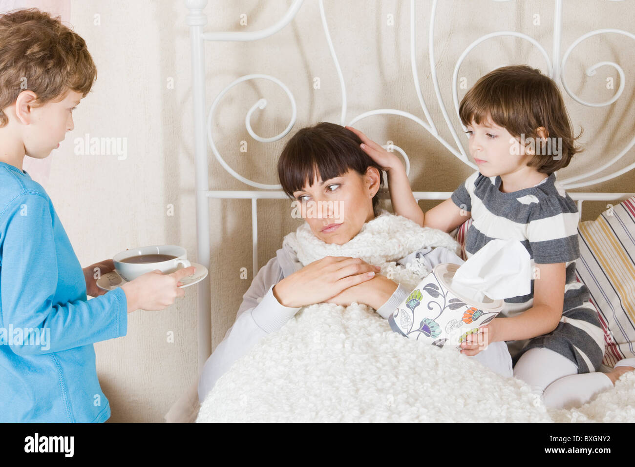 Children taking care of sick mother Stock Photo Alamy
