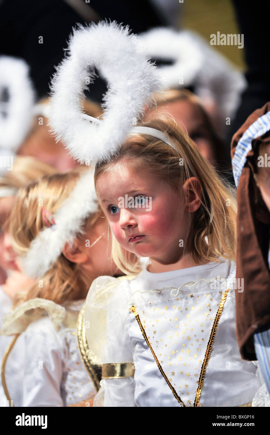 Children dressed as angels performing in a primary school christmas