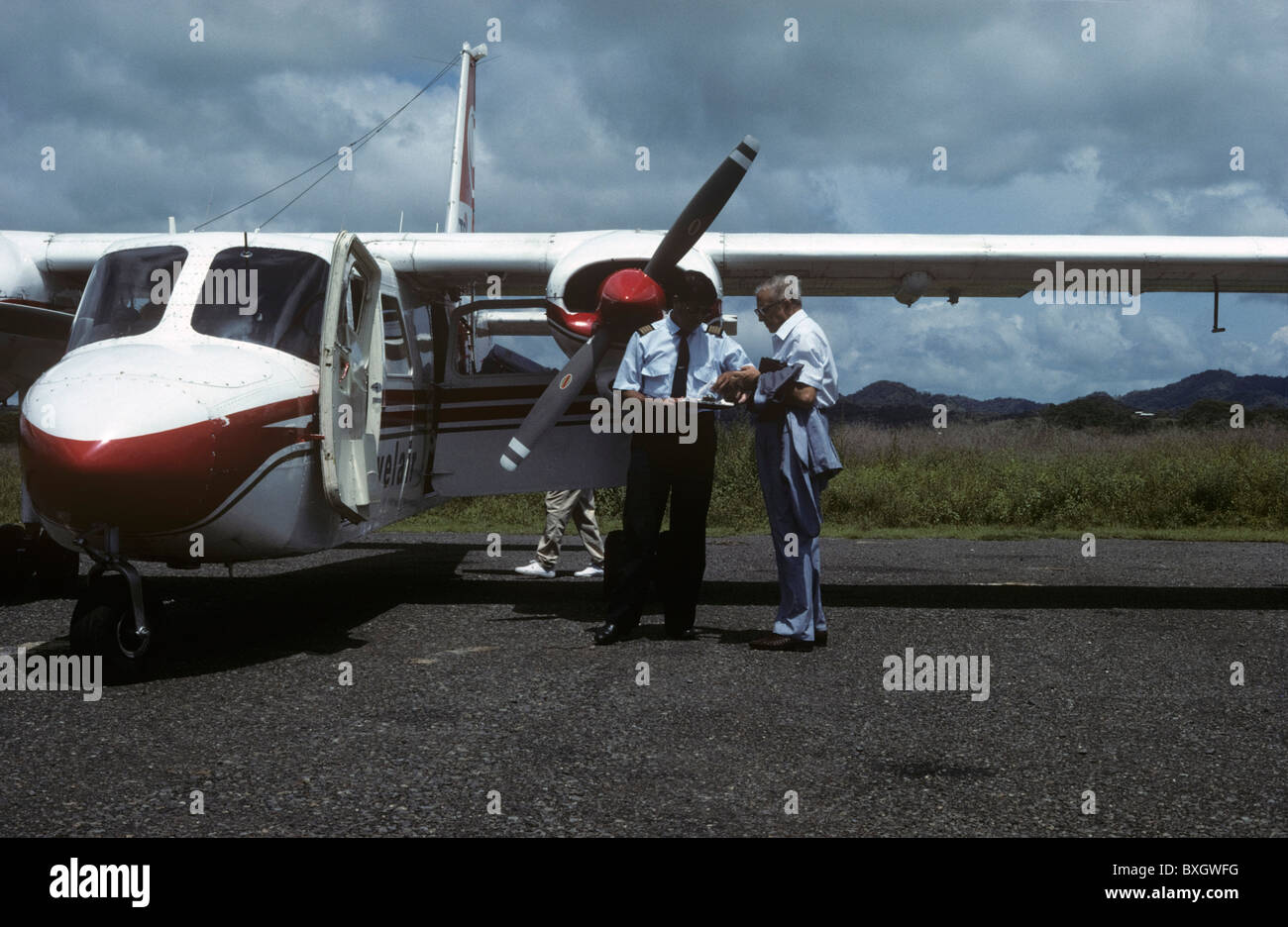 Costa Rica, businessman, entering private airplane, pilot controlling papers Stock Photo