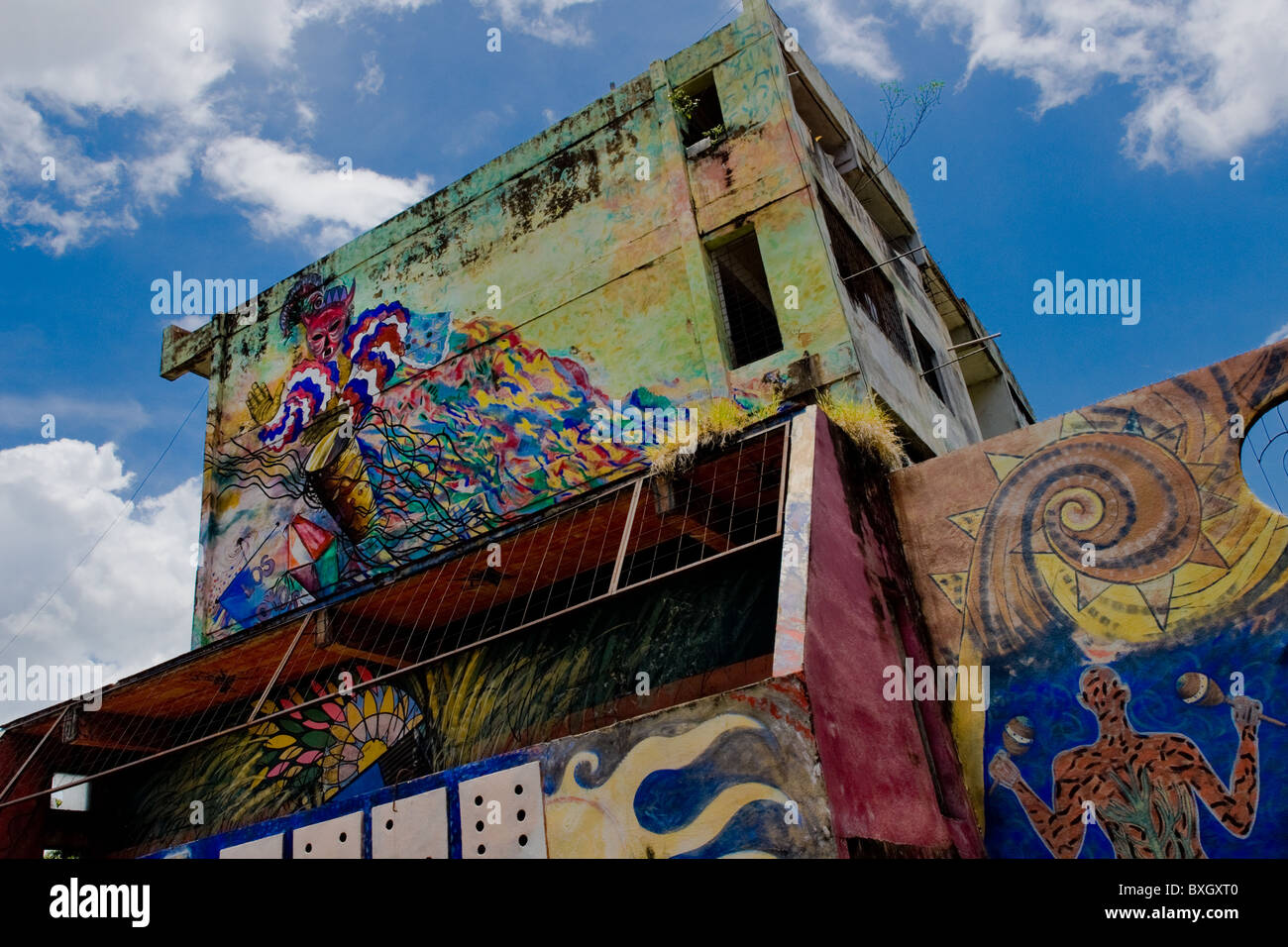 Afro-Cuban traditional themes, showing colorful dance, spirits and rituals, painted on house walls (murals) in Santiago de Cuba. Stock Photo