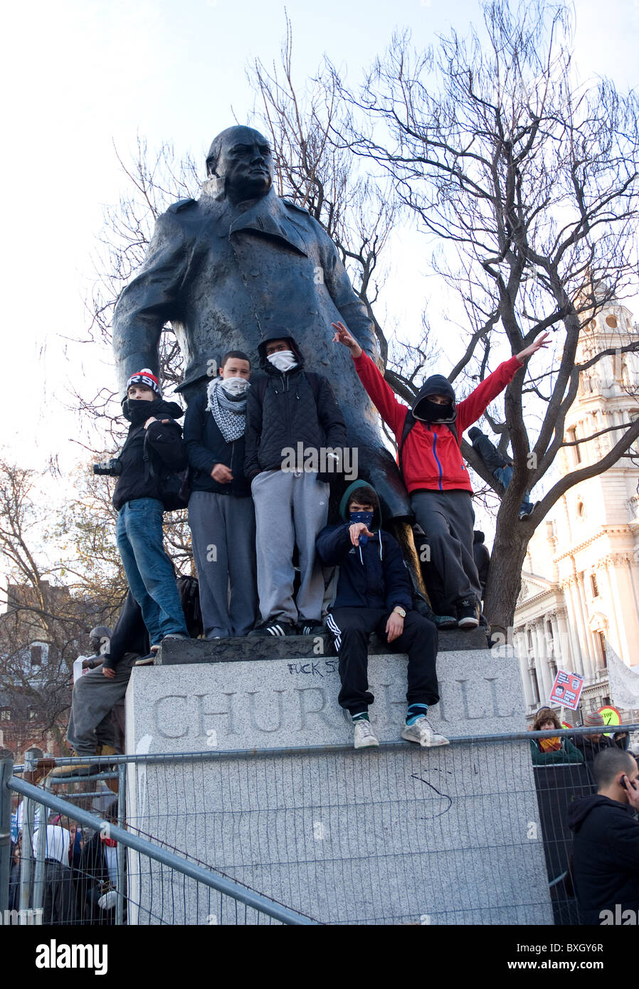 students climb upon Churchill statue during student protest over fees being cut . Stock Photo