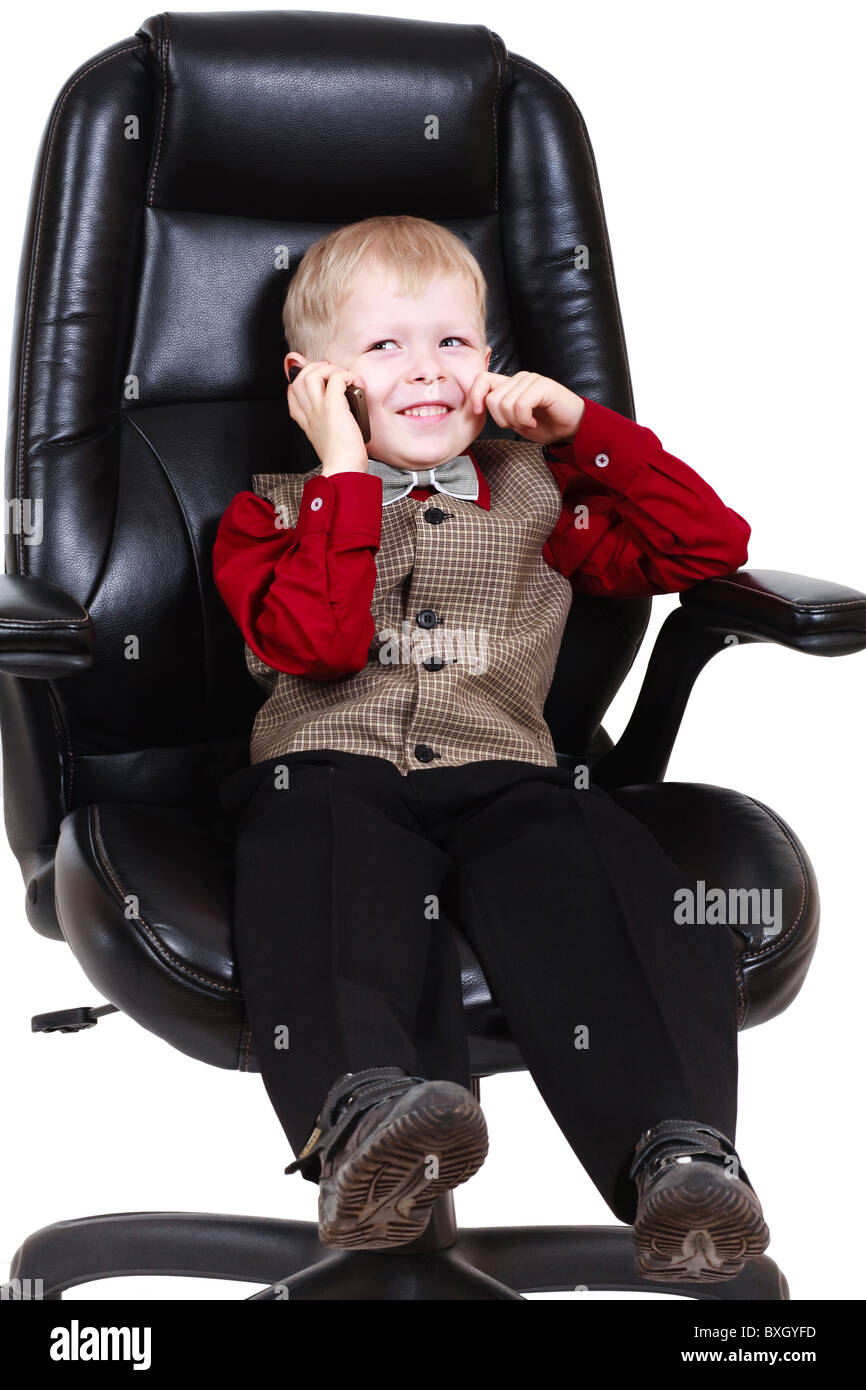 Child businessman boss calling by phone Stock Photo