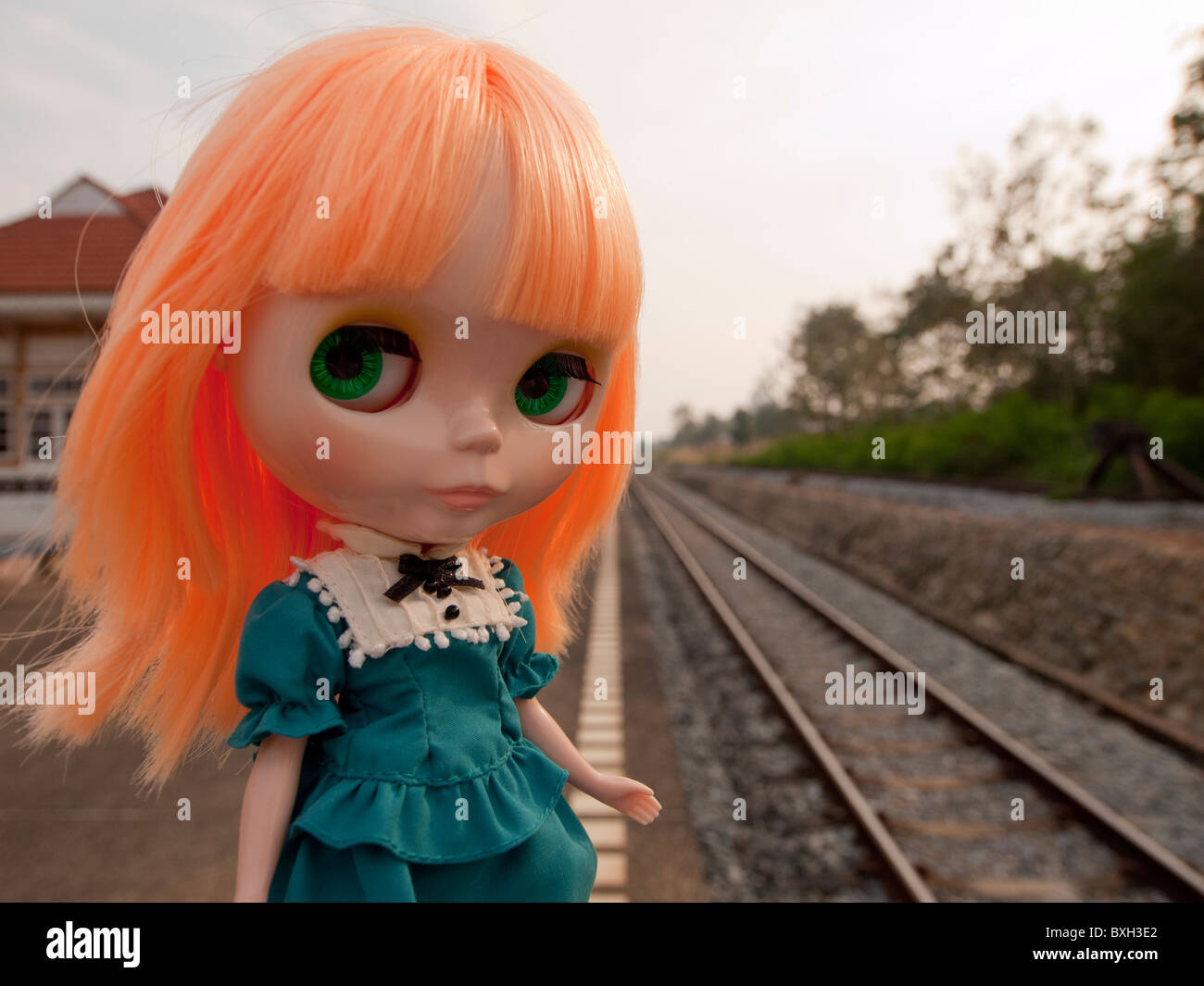 A neo blythe doll standing on the railway station Stock Photo