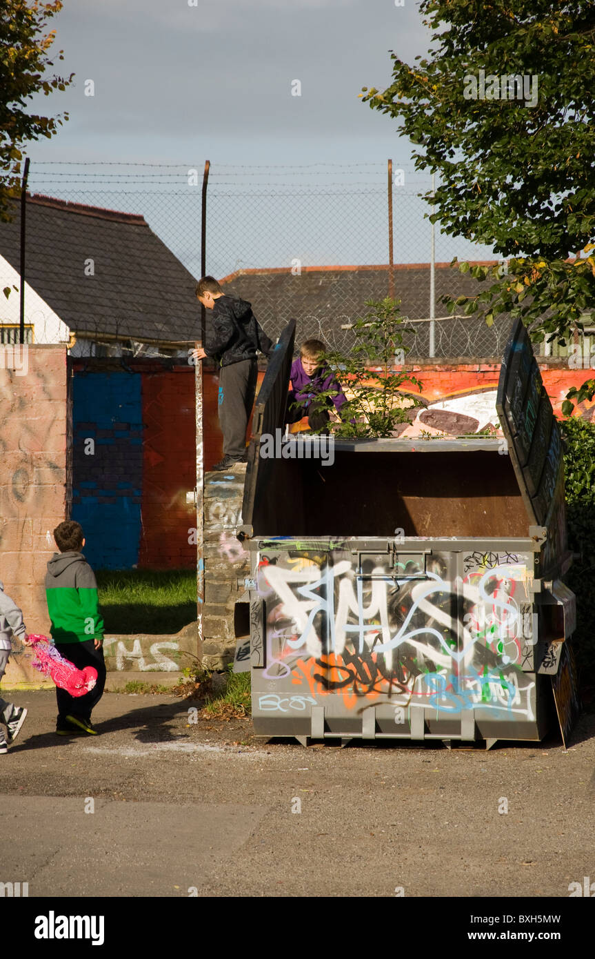 Young Boys Being Inquisitive As To The Contents Of A Skip dumpster In young-boys-being-inquisitive-as-to-the-contents-of-a-skip-dumpster-in