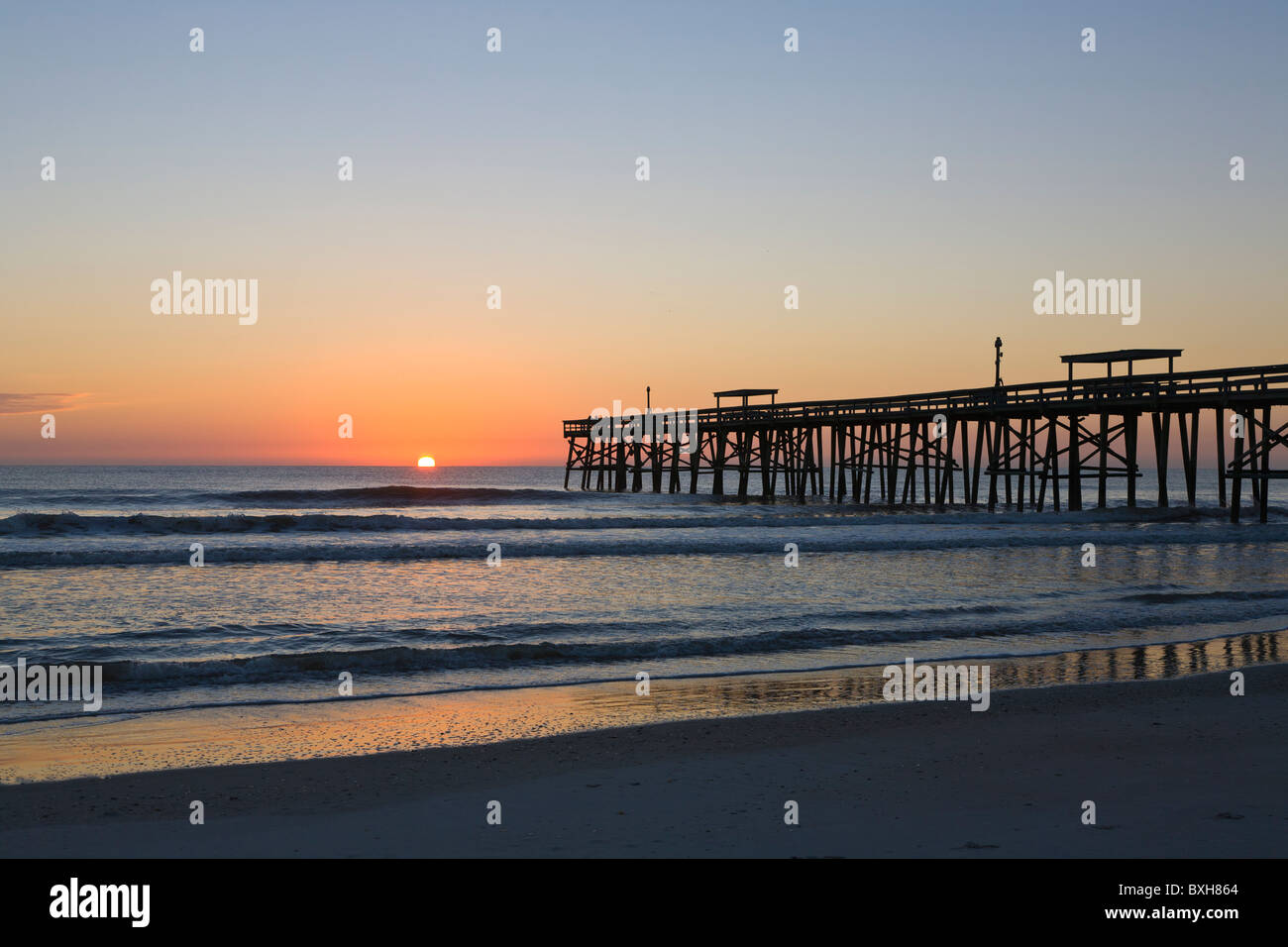 Sunrise over Atlantic Ocean pier on Amelia Island Florida Stock Photo