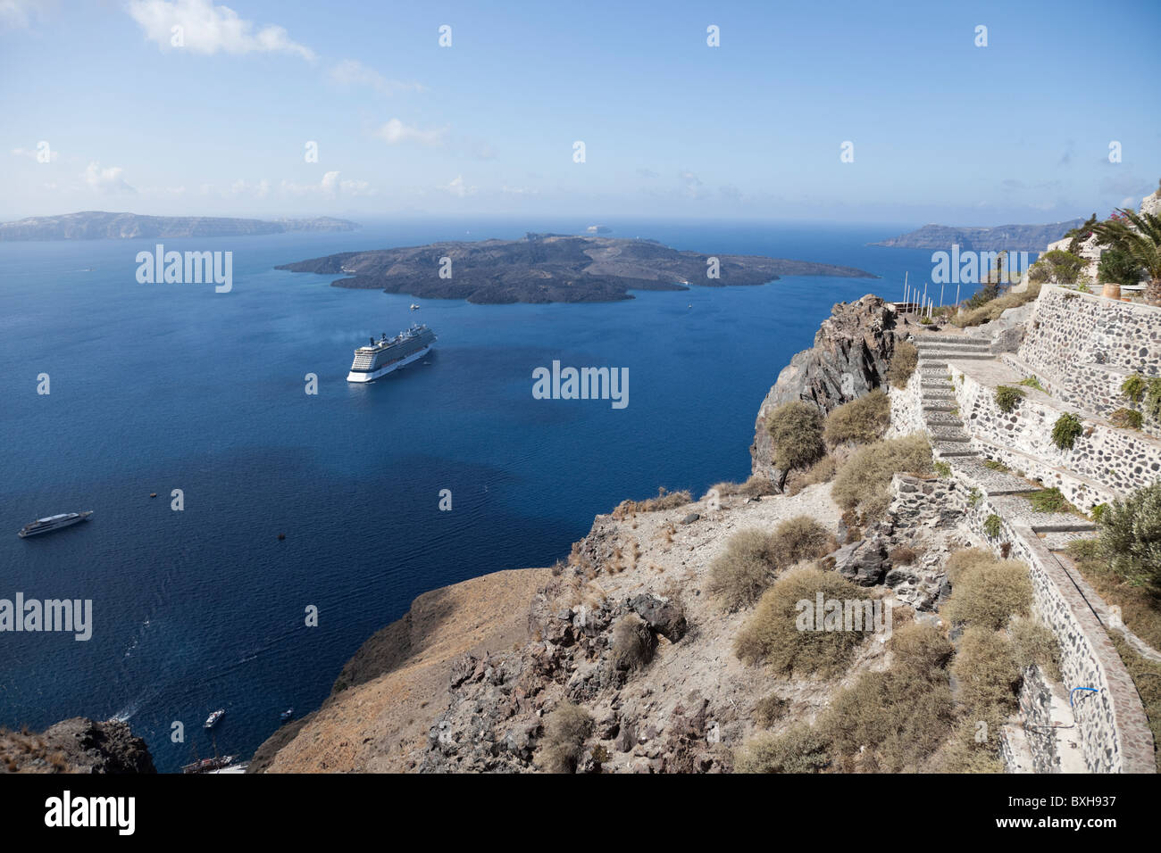 Cruise liner Equinox anchoring off the island Nea Kameni of Santorini's, the view from the top of cliff of Santorini. Stock Photo