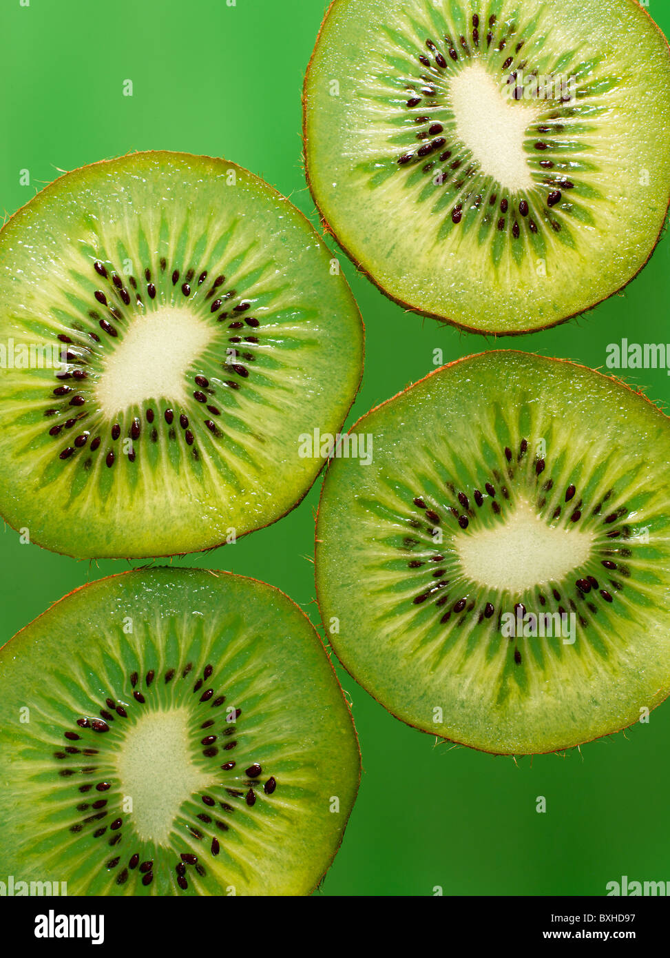 kiwi fruit slices on green background Stock Photo