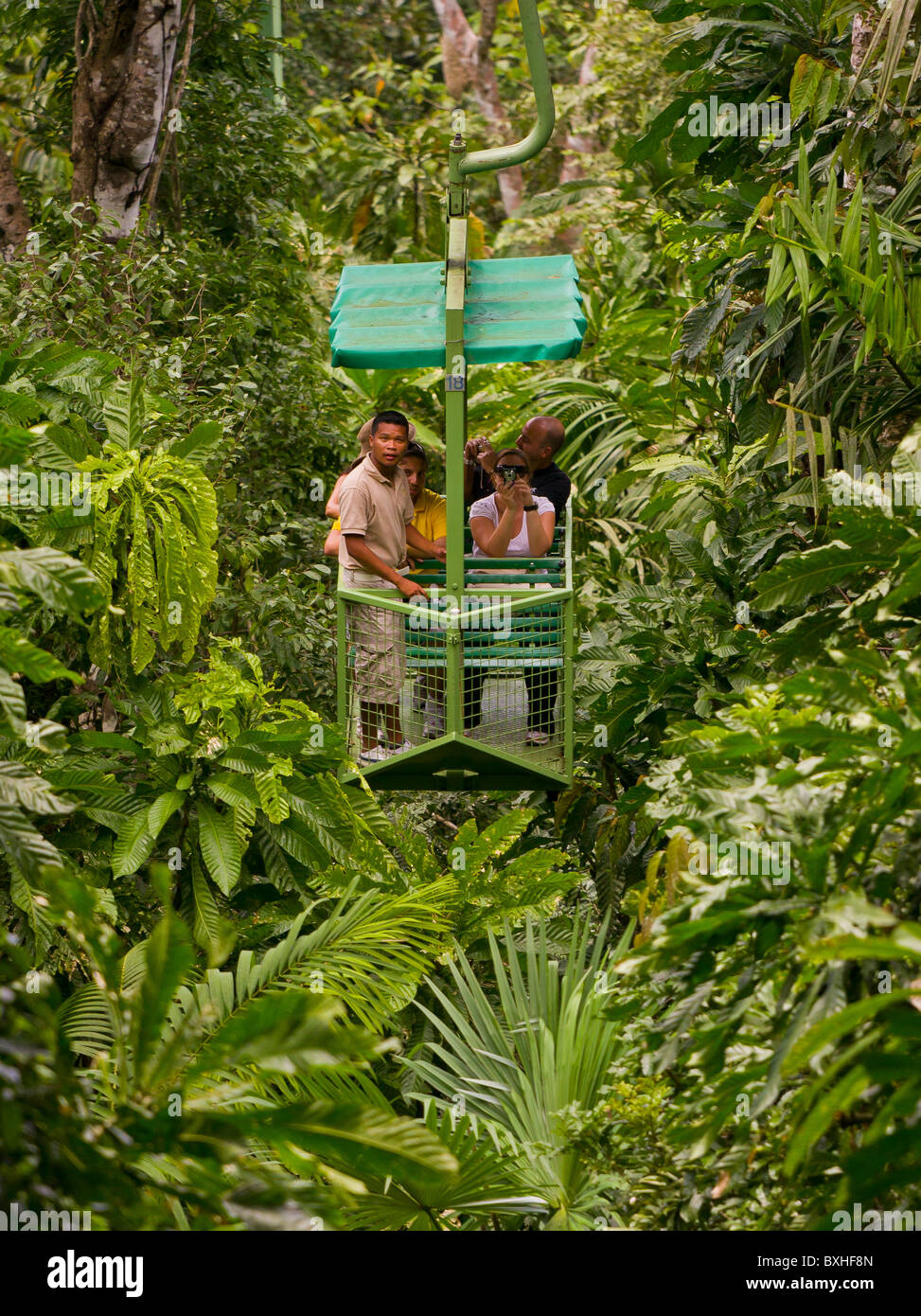 GAMBOA, PANAMA - Tourists and guide in aerial tram teleferico in jungle at Gamboa Rainforest Resort. Stock Photo