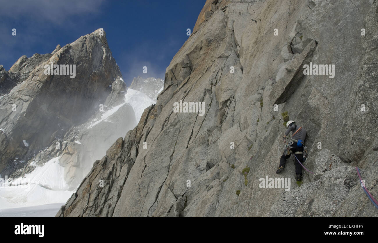 A male rock climber lead climbing on Pyramide du Tacul near Mont Blanc in Chamonix, France. Stock Photo