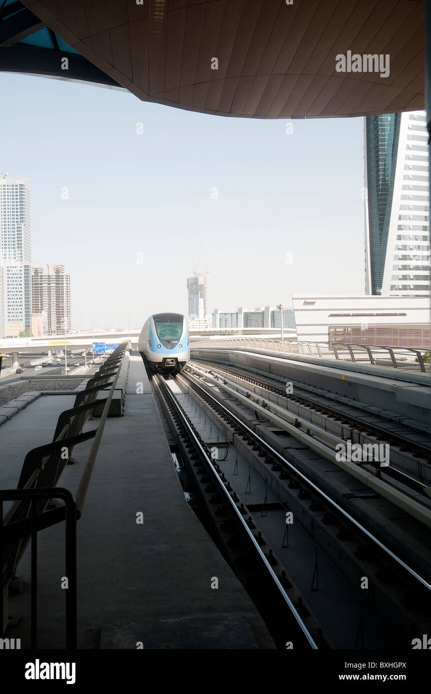 A metro train arrive in a station in Dubai Stock Photo