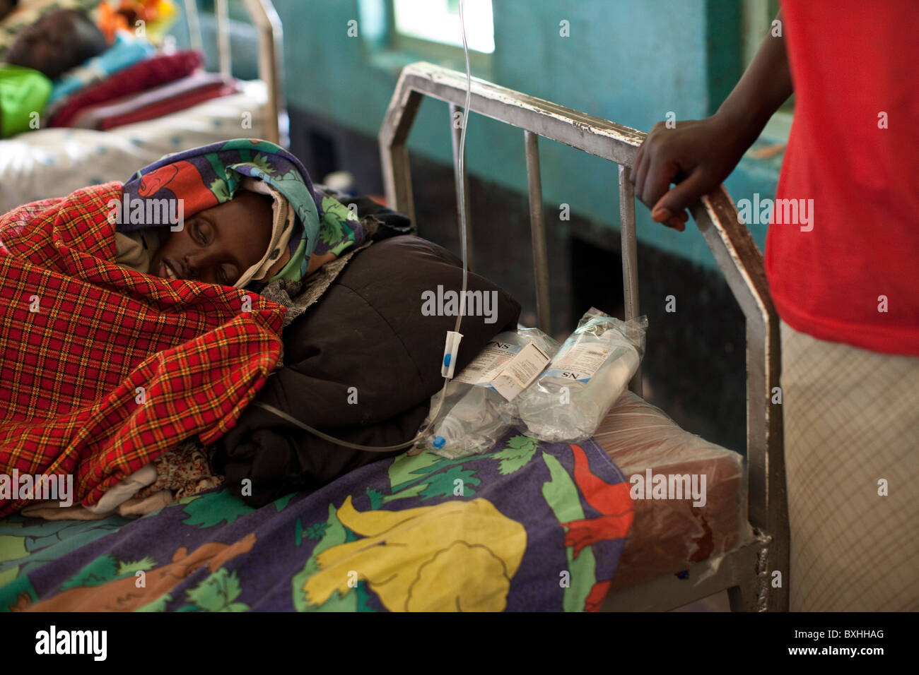 A woman grieves for her daughter dying of AIDS in Amuria, Uganda, East Africa. Stock Photo