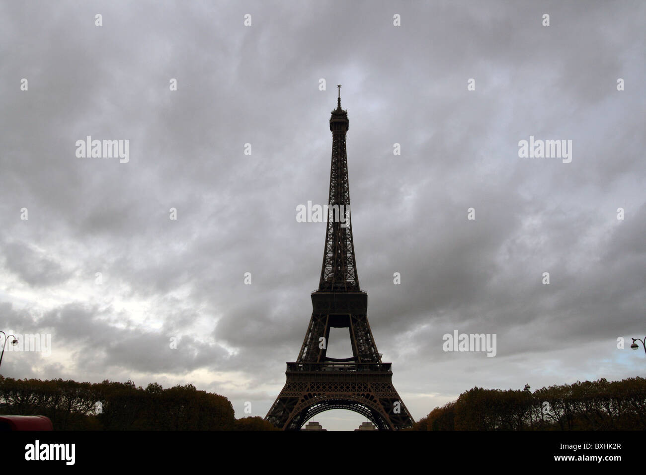 The Eiffel Tower under cloudy skies during sunset. Stock Photo