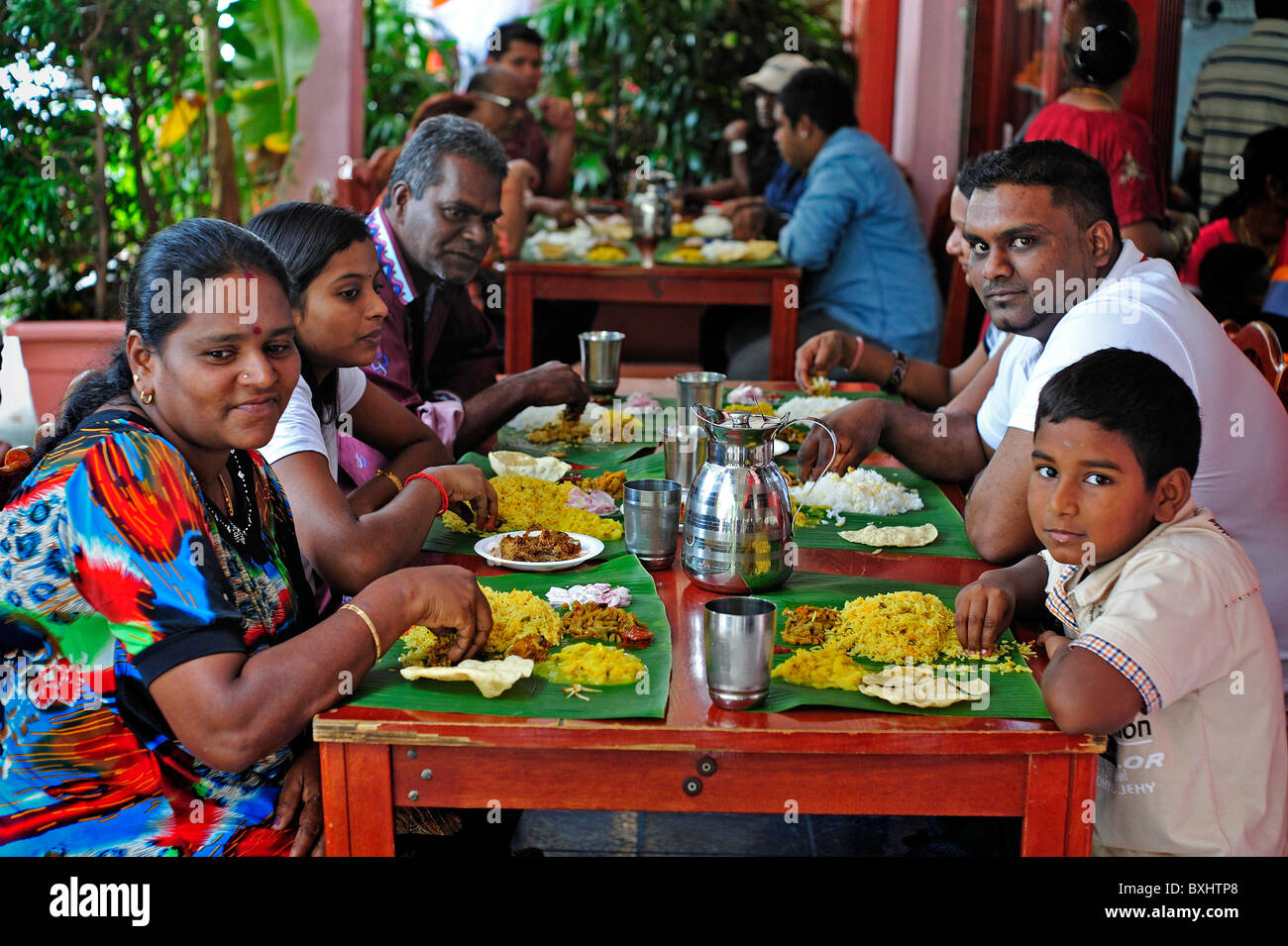 Indian Family eating meal together in Little India Singapore Stock Photo