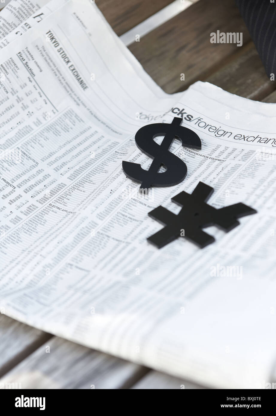 Yen sign, dollar sign, and English newspaper Stock Photo