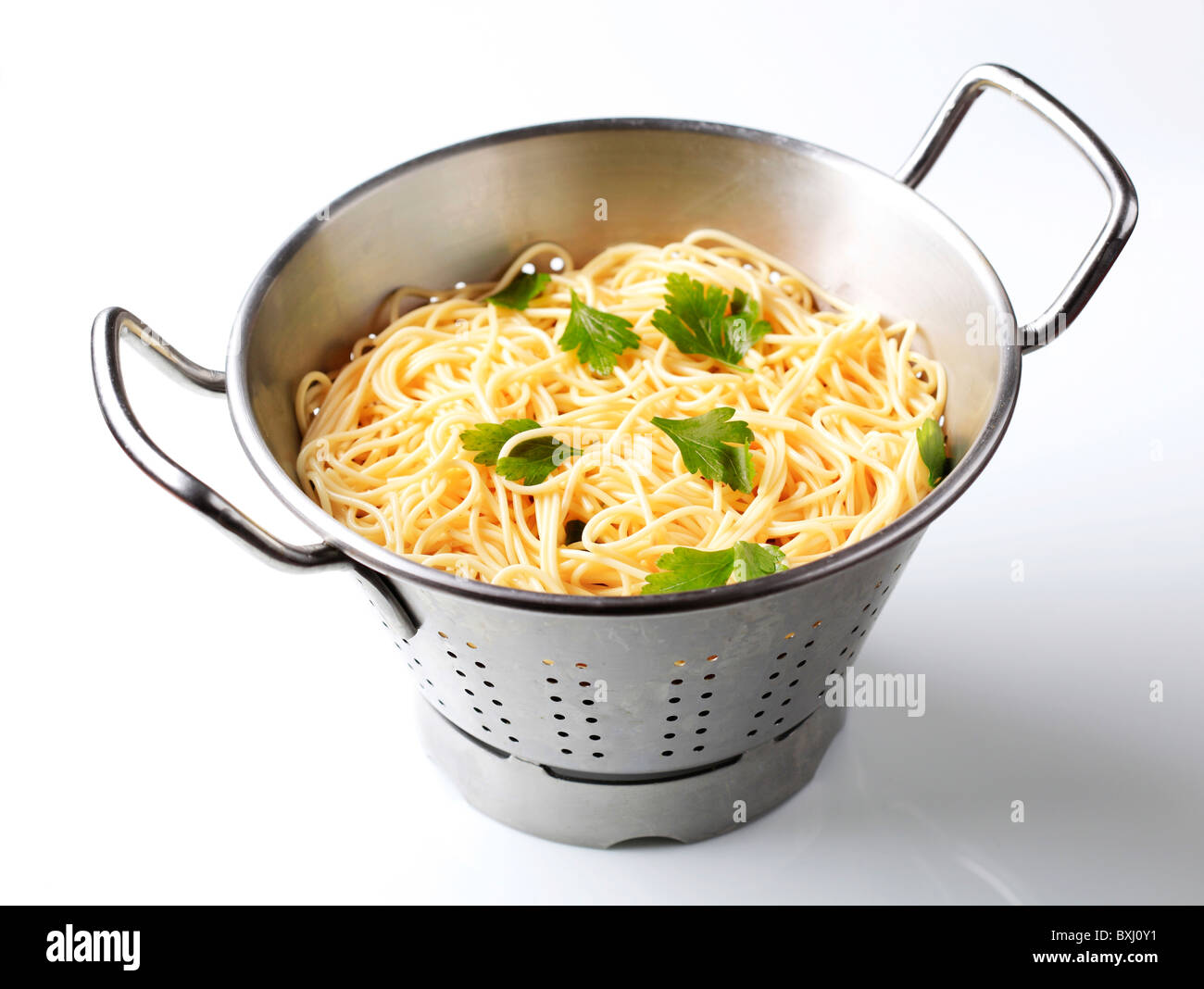 Cooked spaghetti in a colander Stock Photo