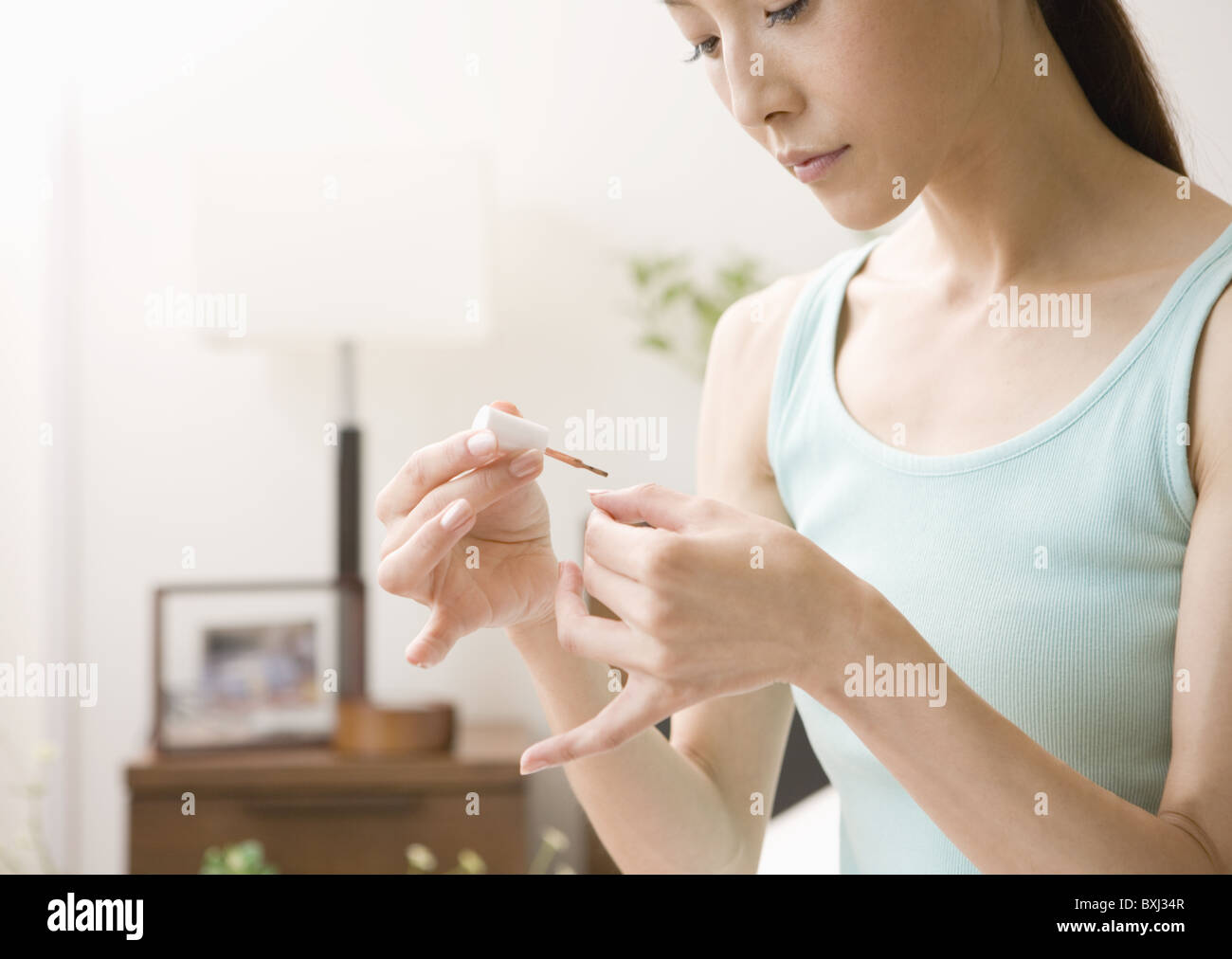 A woman painting her nails Stock Photo Alamy