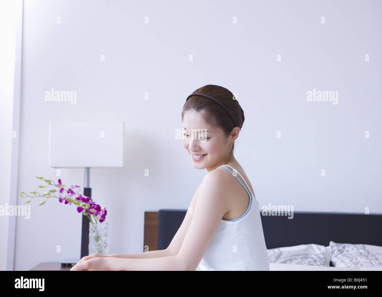 Woman relaxing on bed Stock Photo - Alamy