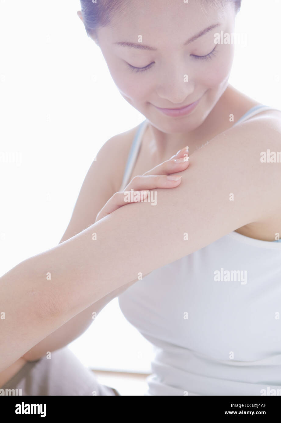 Woman massaging her arms Stock Photo Alamy