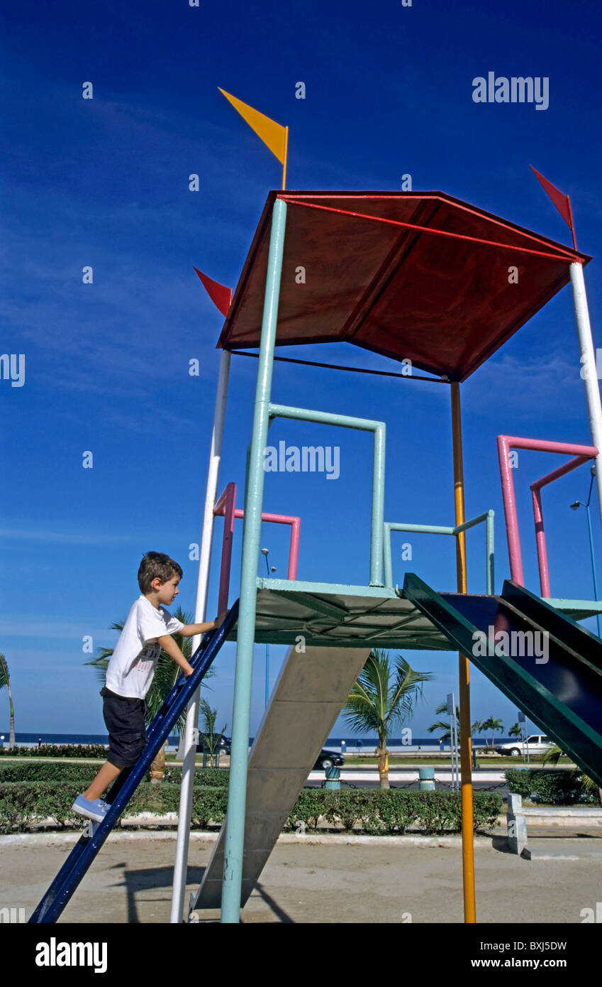 Young boy on a slide in a playground, Campeche, Mexico. Stock Photo