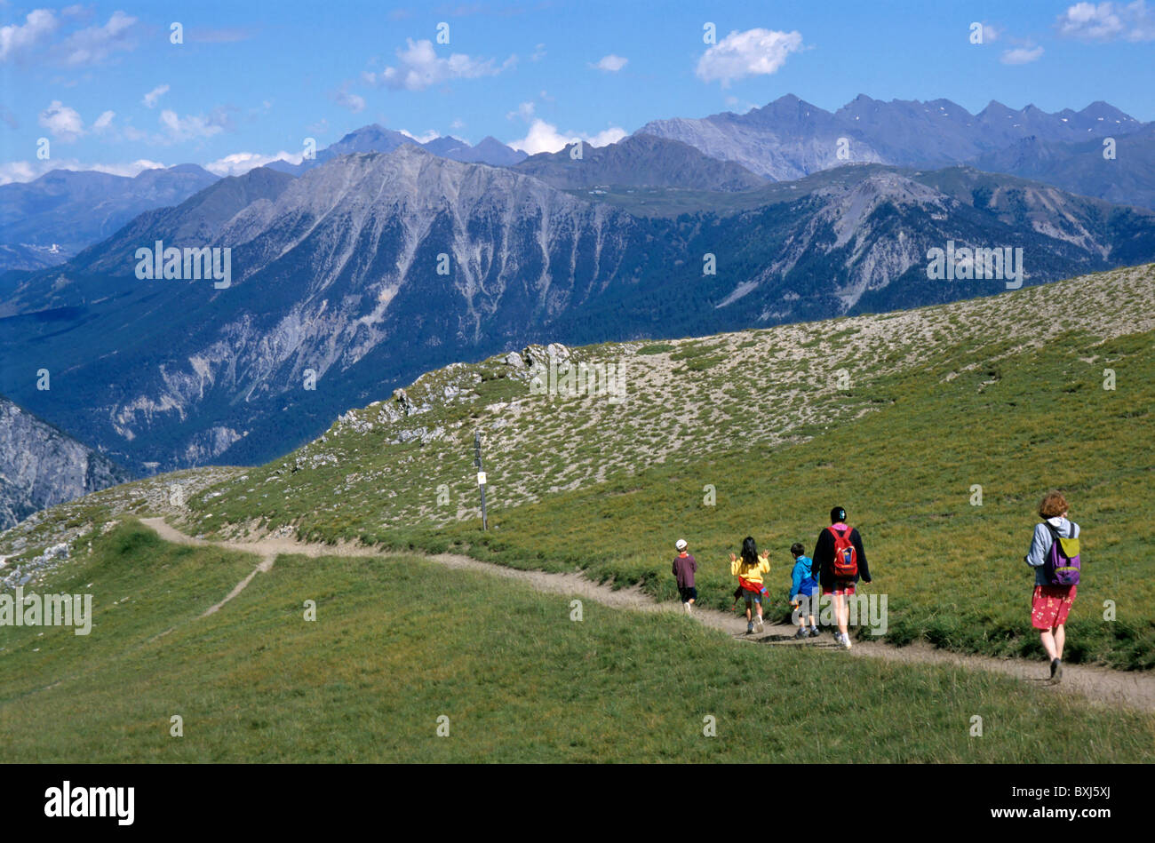 Family hiking with children in the French Alps in summer near Briancon in Serre Chevalier region, Haute Alpes, France Stock Photo
