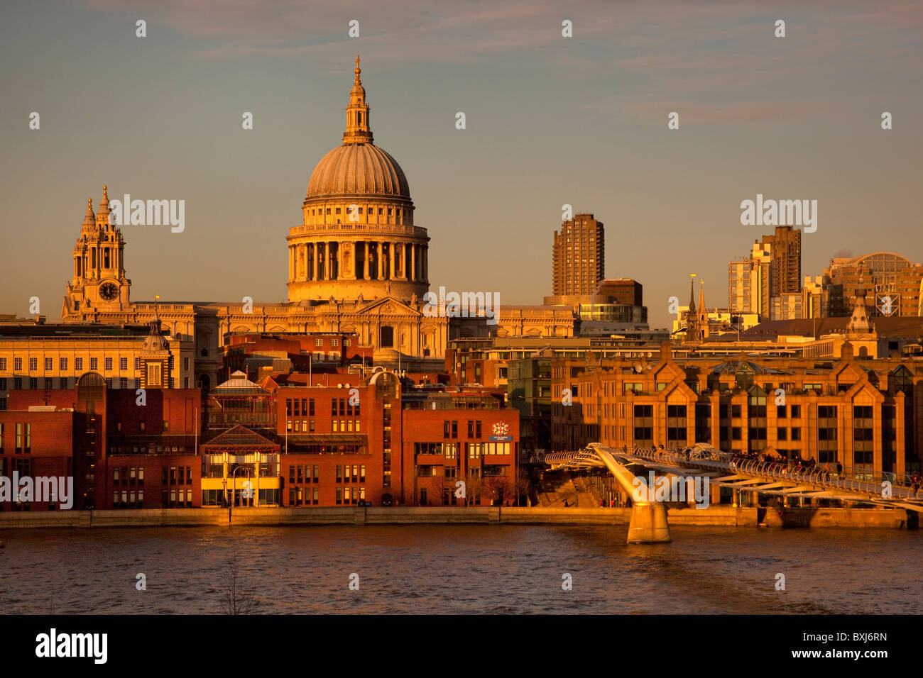 Late afternoon light on St Paul's Cathedral and Millennium bridge from Tate Modern on south bank of Thames, London, England Stock Photo