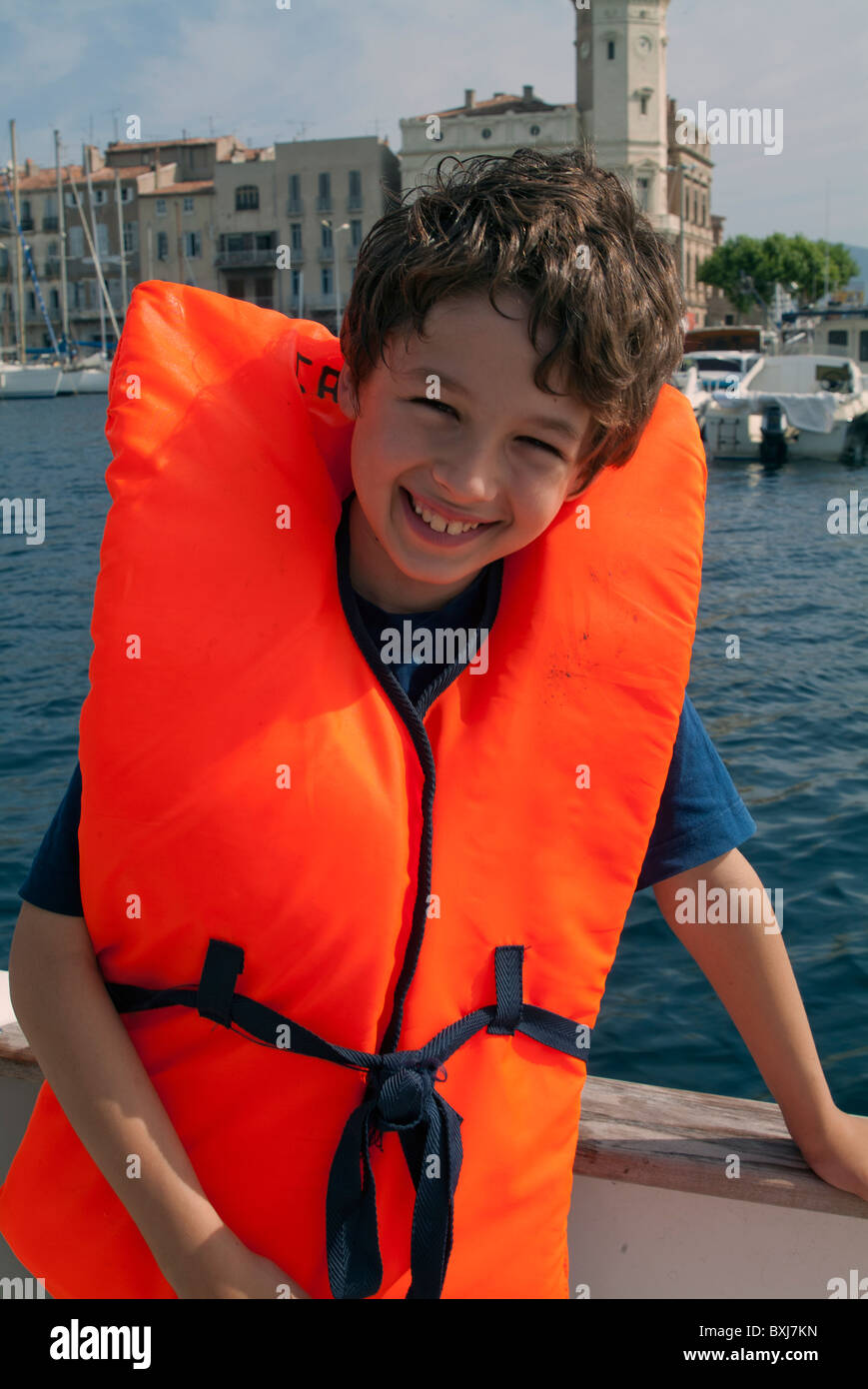 Young boy wearing a life jacket on board a boat, La Ciotat, Provence