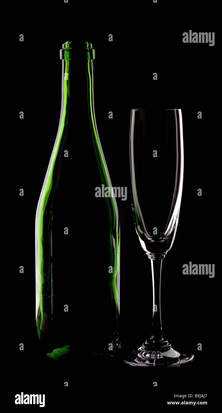 green glass bottle of wine and wineglass on black background Stock Photo