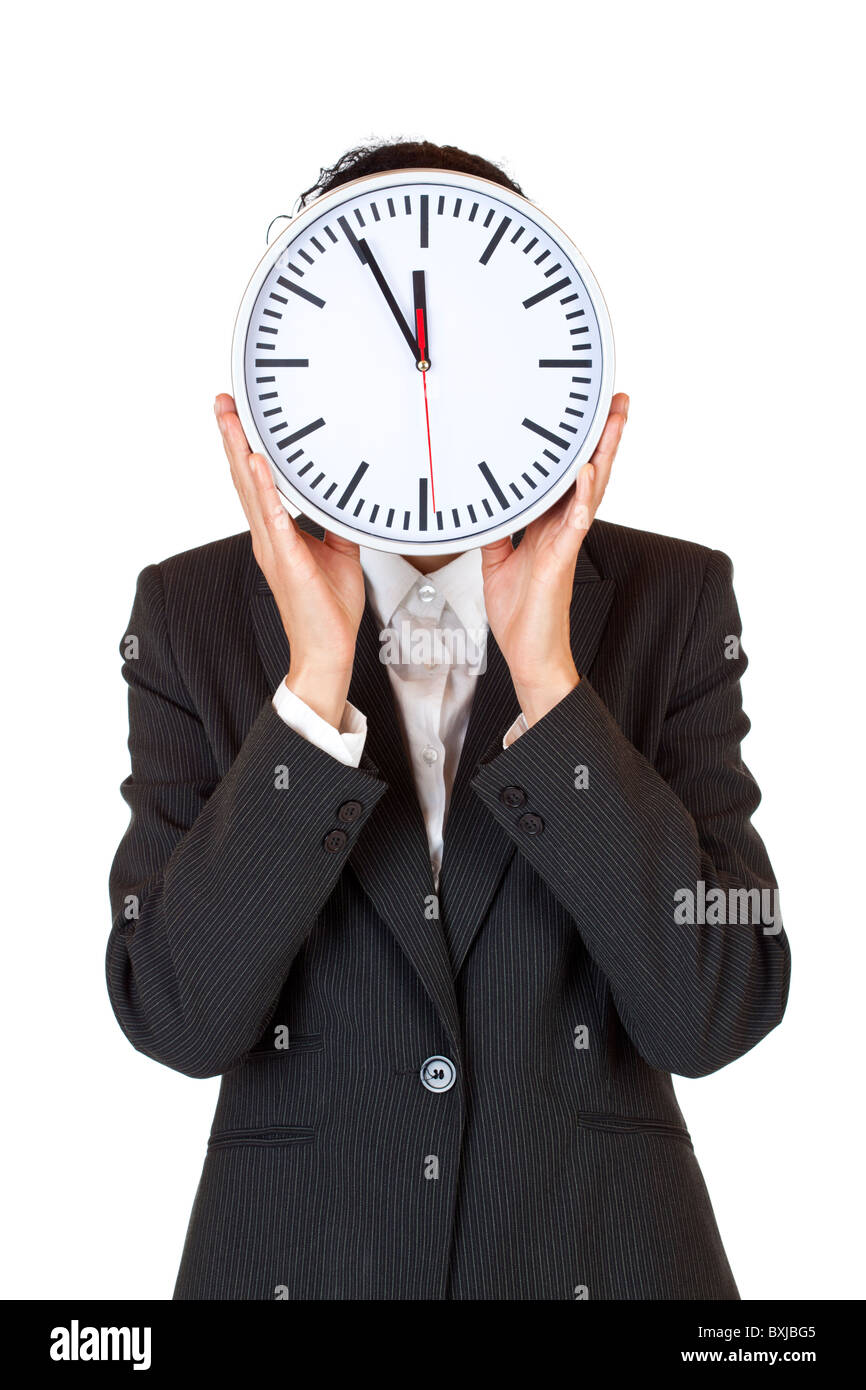 Woman with clock in front of face express stress by time pressure. Isolated on white background. Stock Photo