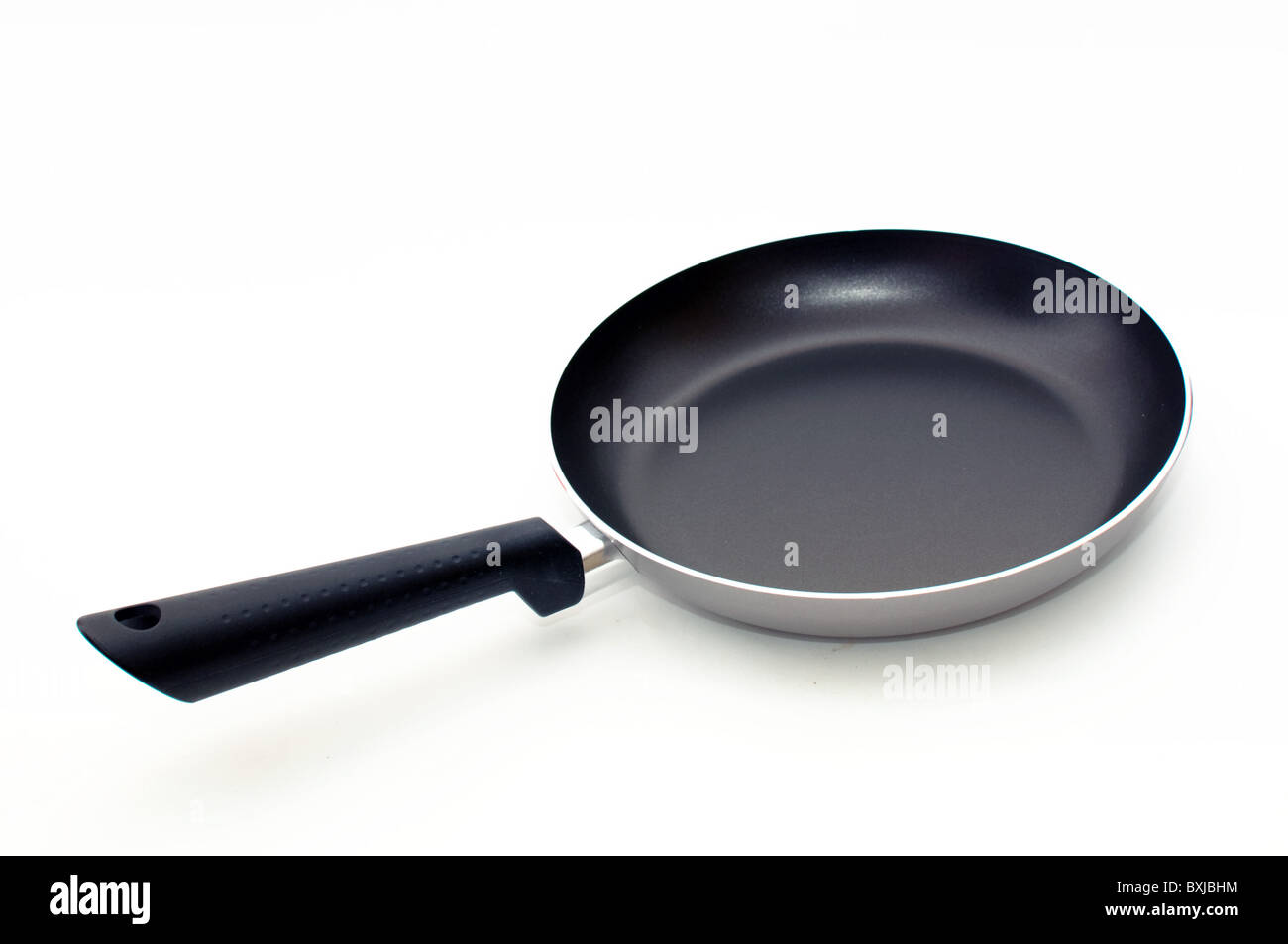 Large metal frying pan, image is taken over a white background Stock Photo