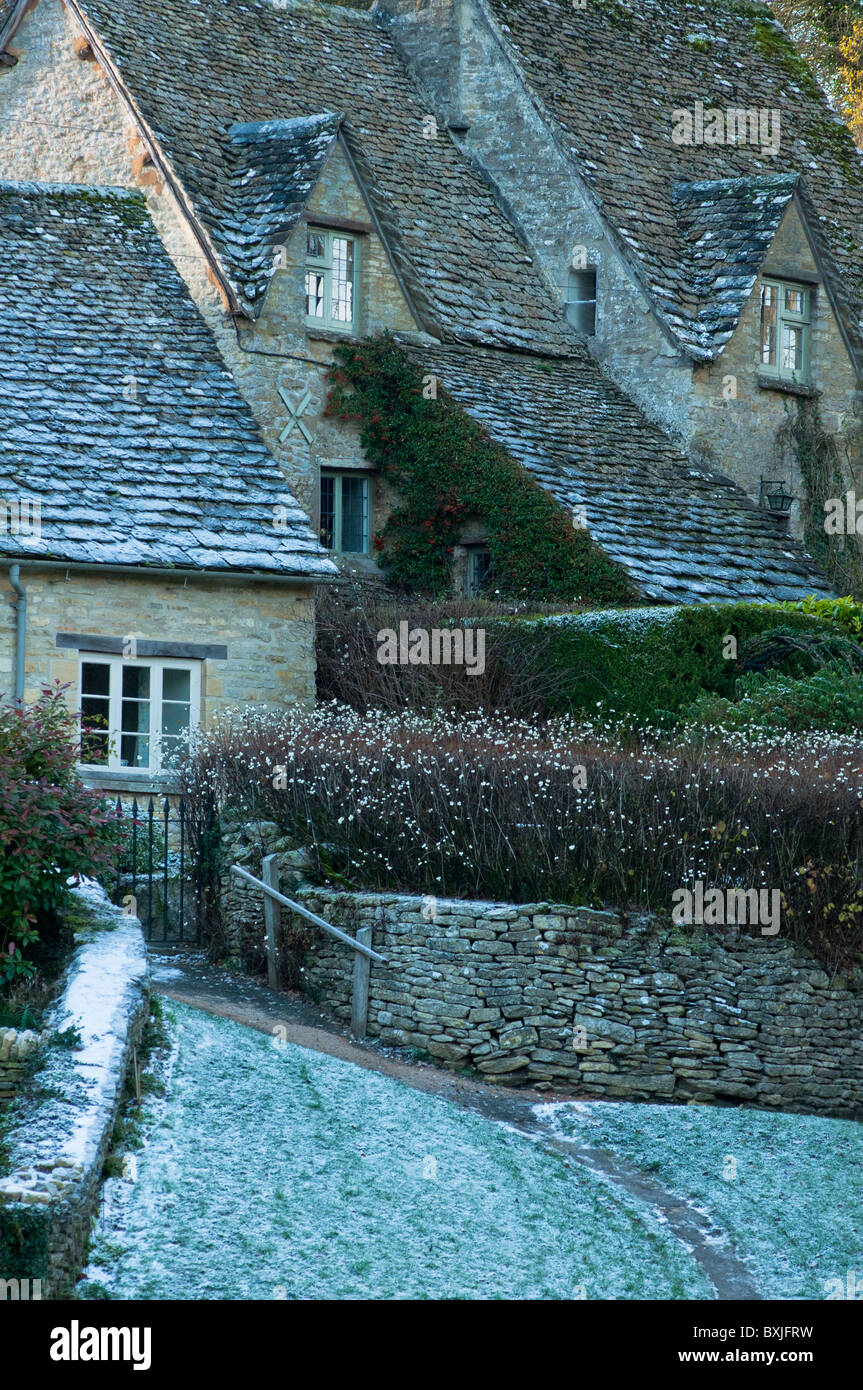 A rustic cottage on a cold frosty morning in the Cotswold village of Bibury in Gloucestershire, England Stock Photo