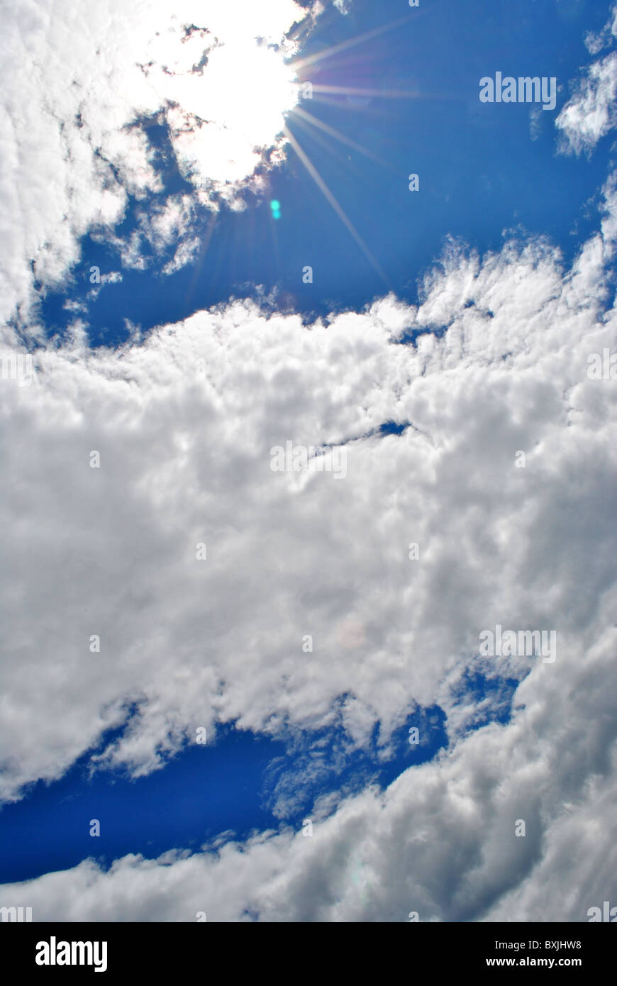 sun against the blue sky with white clouds Stock Photo - Alamy