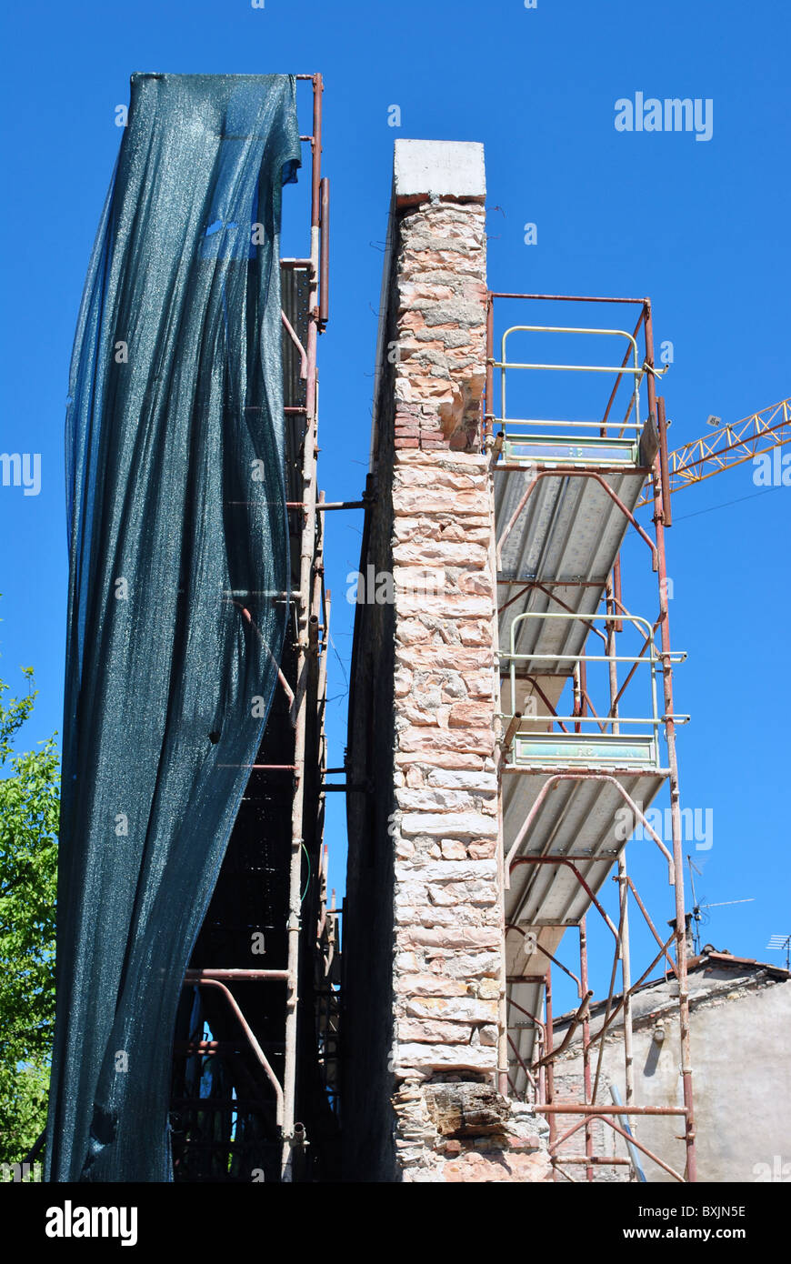 rebuilding the wall with piers and metal safety net fall Stock Photo