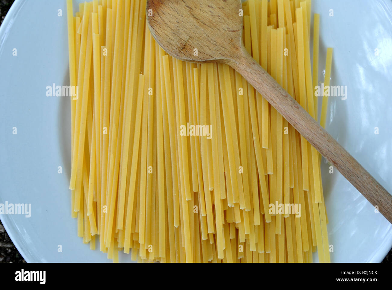 spaghetti dishes before cooking ladle with larch wood Stock Photo Alamy