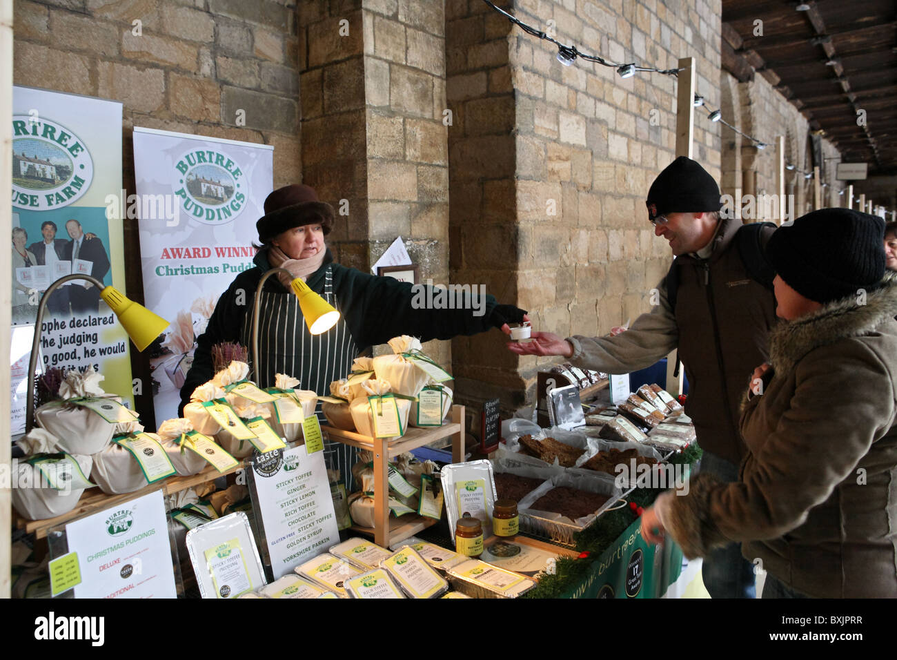 This section of Durham Xmas market is held within the cloisters of Durham Cathedral Stock Photo