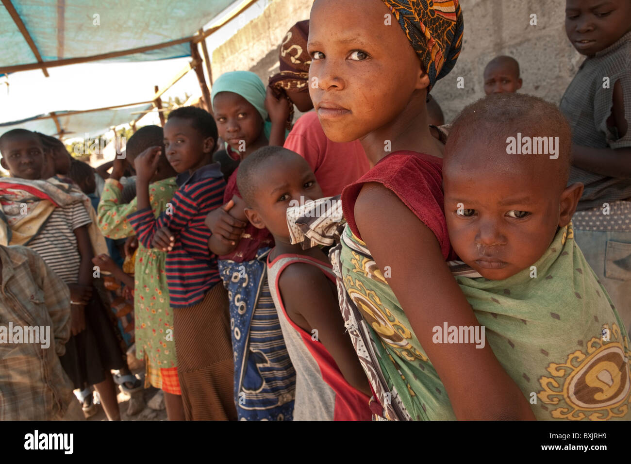Children wait in a food distribution in Mererani, Tanzania, East Africa. Stock Photo