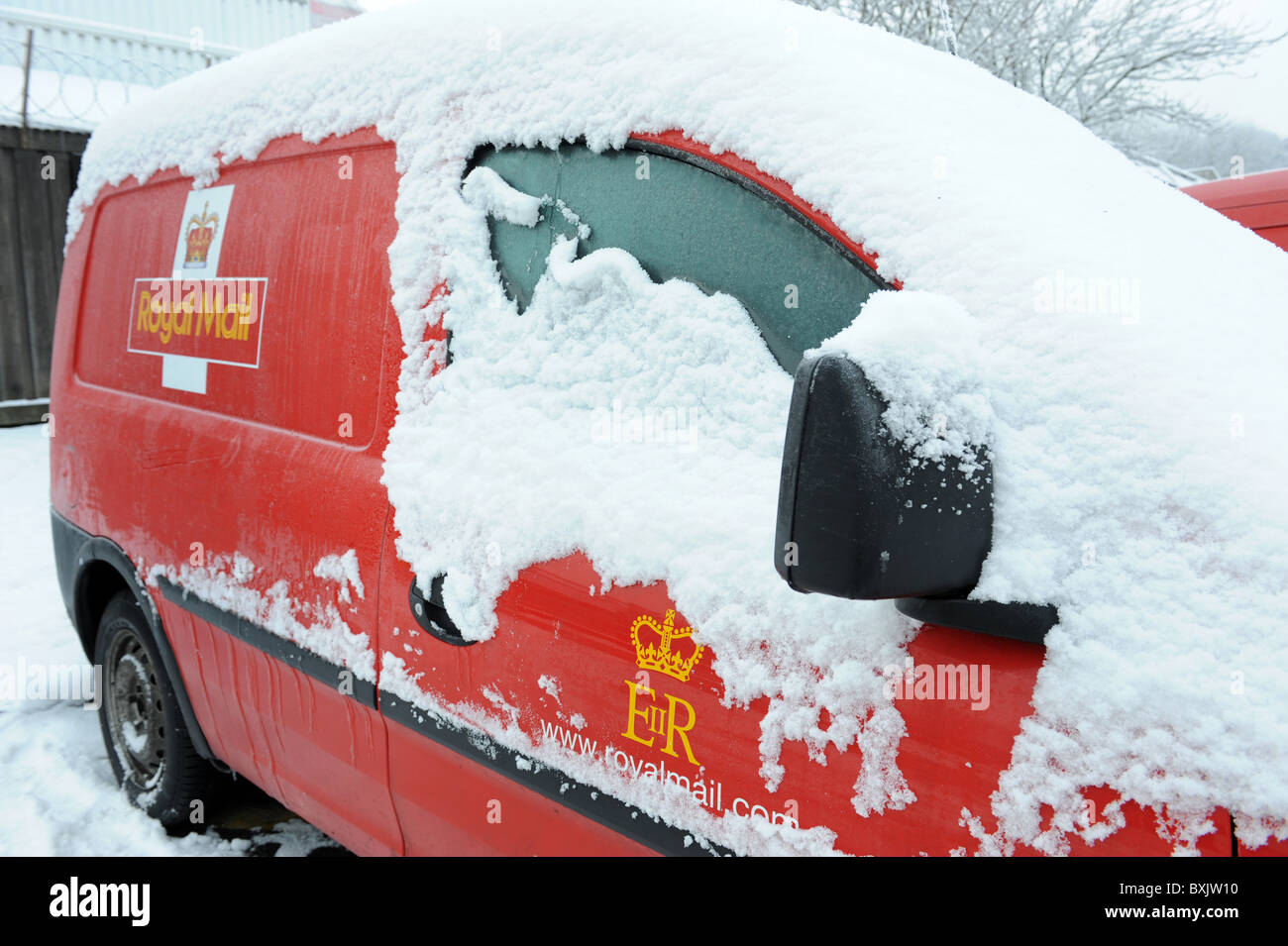 Royal Mail postal delivery van covered in snow and ice as the winter