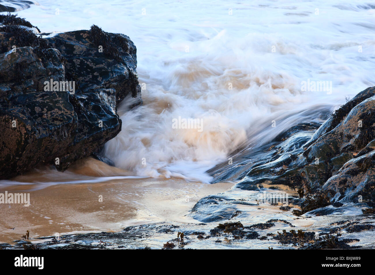 The sea surges through Lewisian Gneiss rock Stock Photo