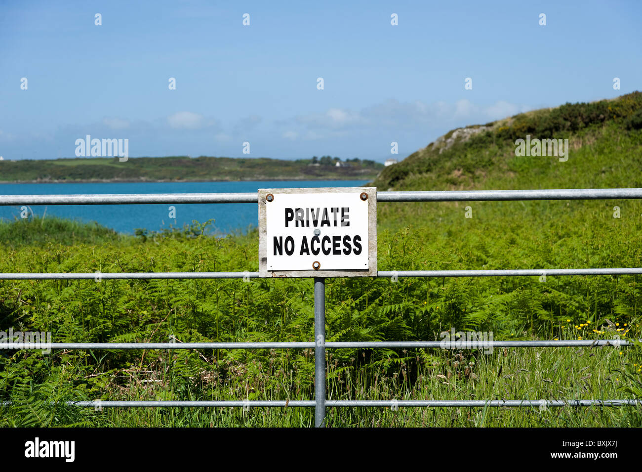 Private No Access sign across barrier on coastal land on Sherkin Island, County Cork, Ireland Stock Photo
