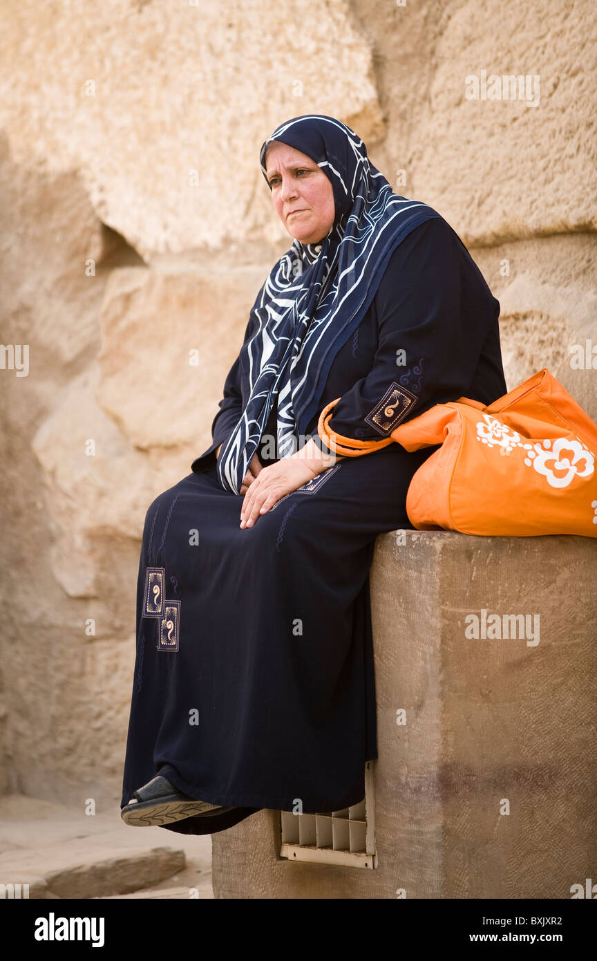 Elderly Muslim Arab Woman in Black Nikab and Abaya with a Handbag