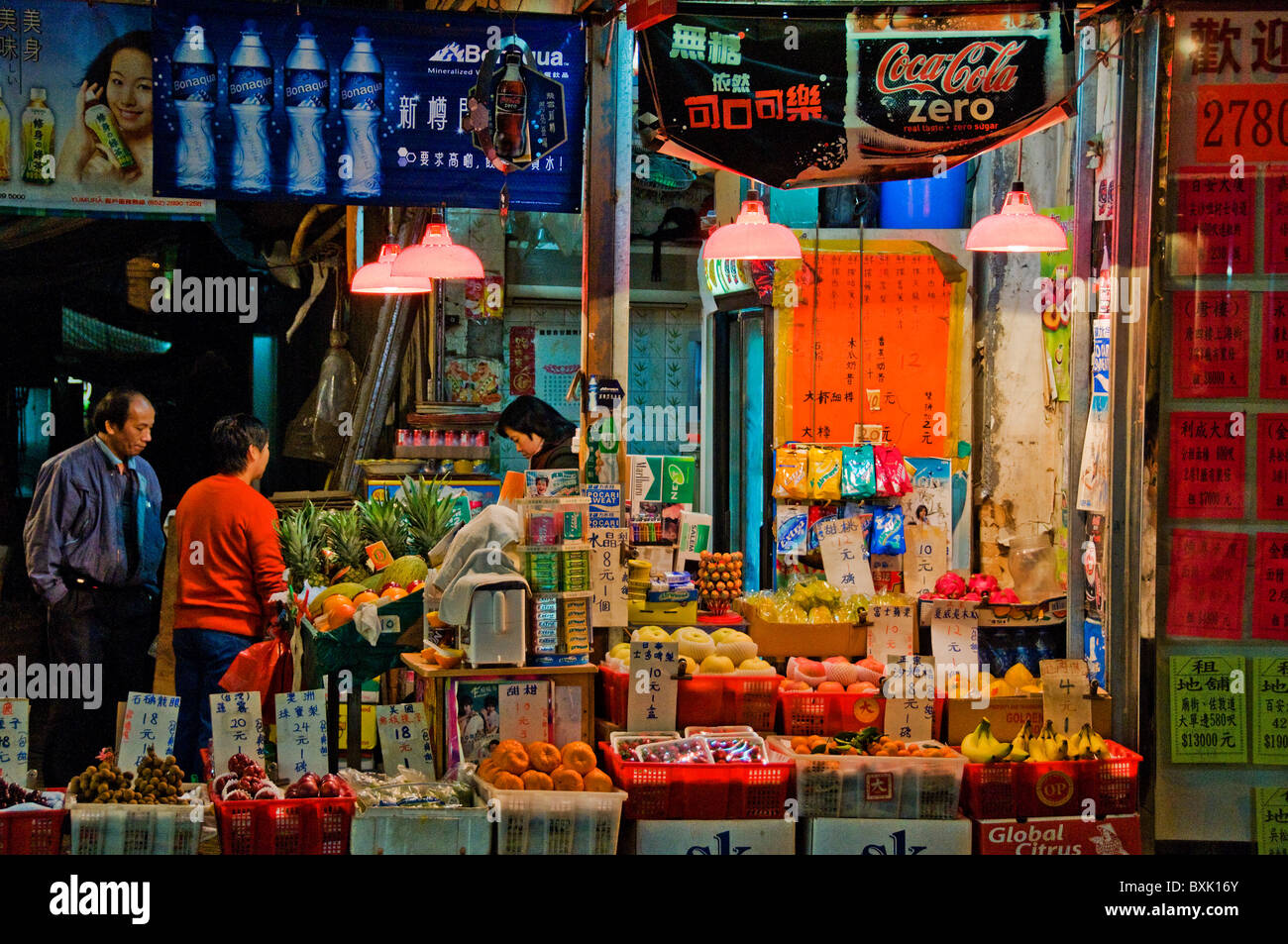 Oriental customers in front of fruit and vegetable market in downtown Hong Kong China Stock