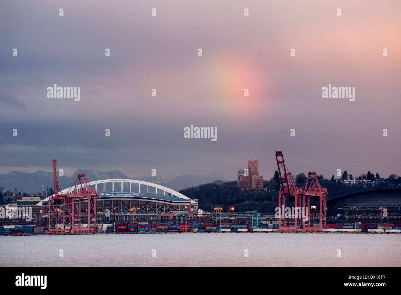 A rainbow appears over Qwest Field, home of the Seattle Seahawks football team looking across Elliott Bay in Seattle, USA. Stock Photo