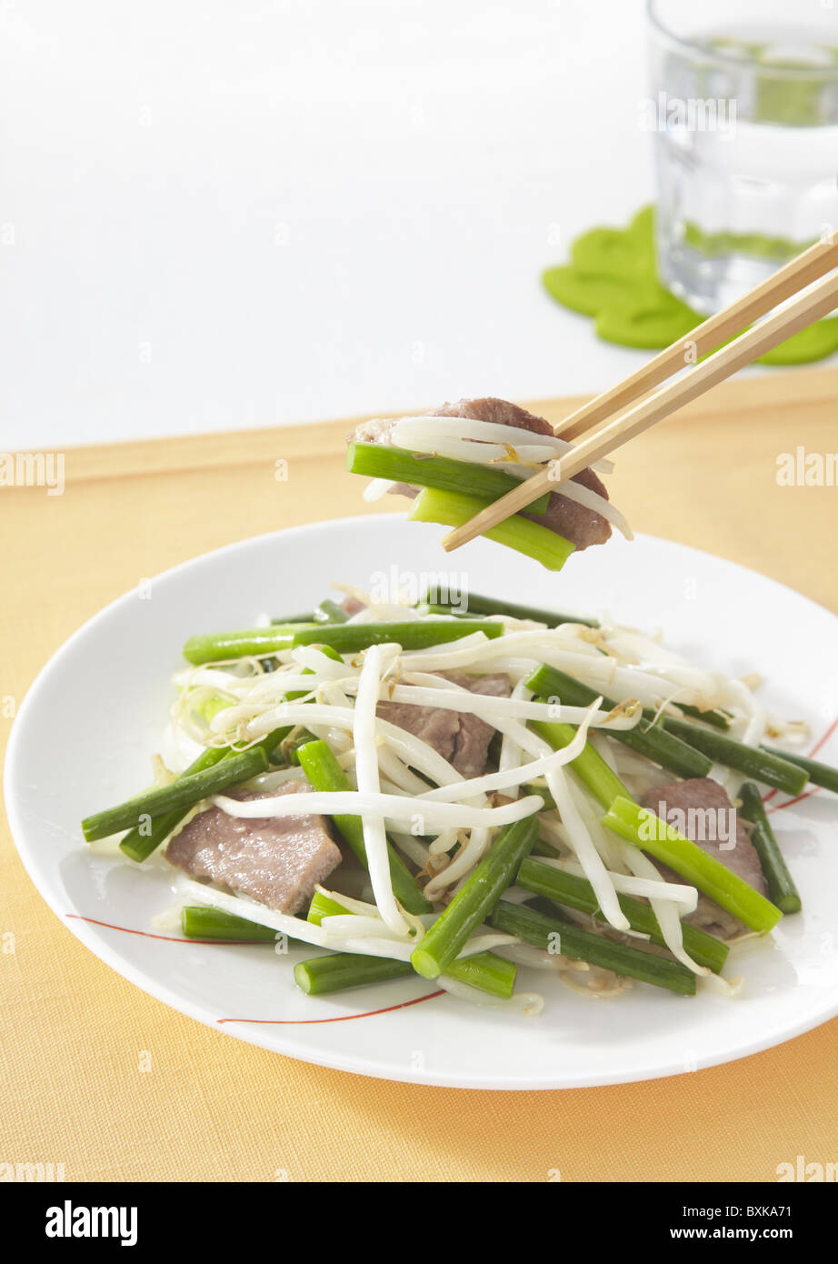 Stir fried pork and garlic stems Stock Photo Alamy
