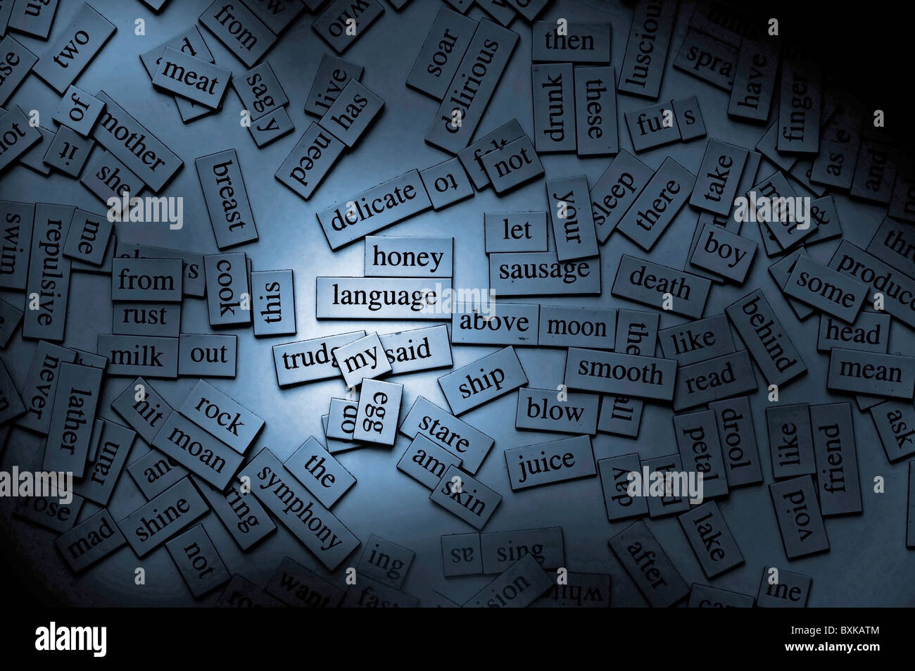 Moody lighting on word tiles, with the focus on the word