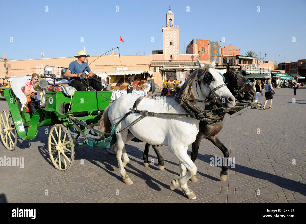 Caleche, one of the best ways to see Marakech,   passing through the busy Djemaa el-Fna meeting place Stock Photo