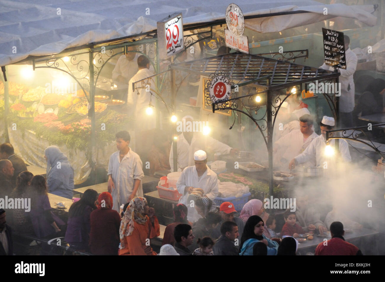 View onto Foodstalls at night from Cafe Glacier at the busy Djemaa el-Fna meeting place Stock Photo