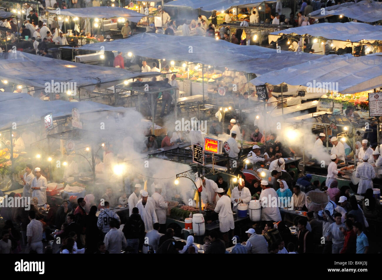View onto Foodstalls at night from Cafe Glacier at busy Djemaa el-Fna  meeting place in Marrakech Stock Photo