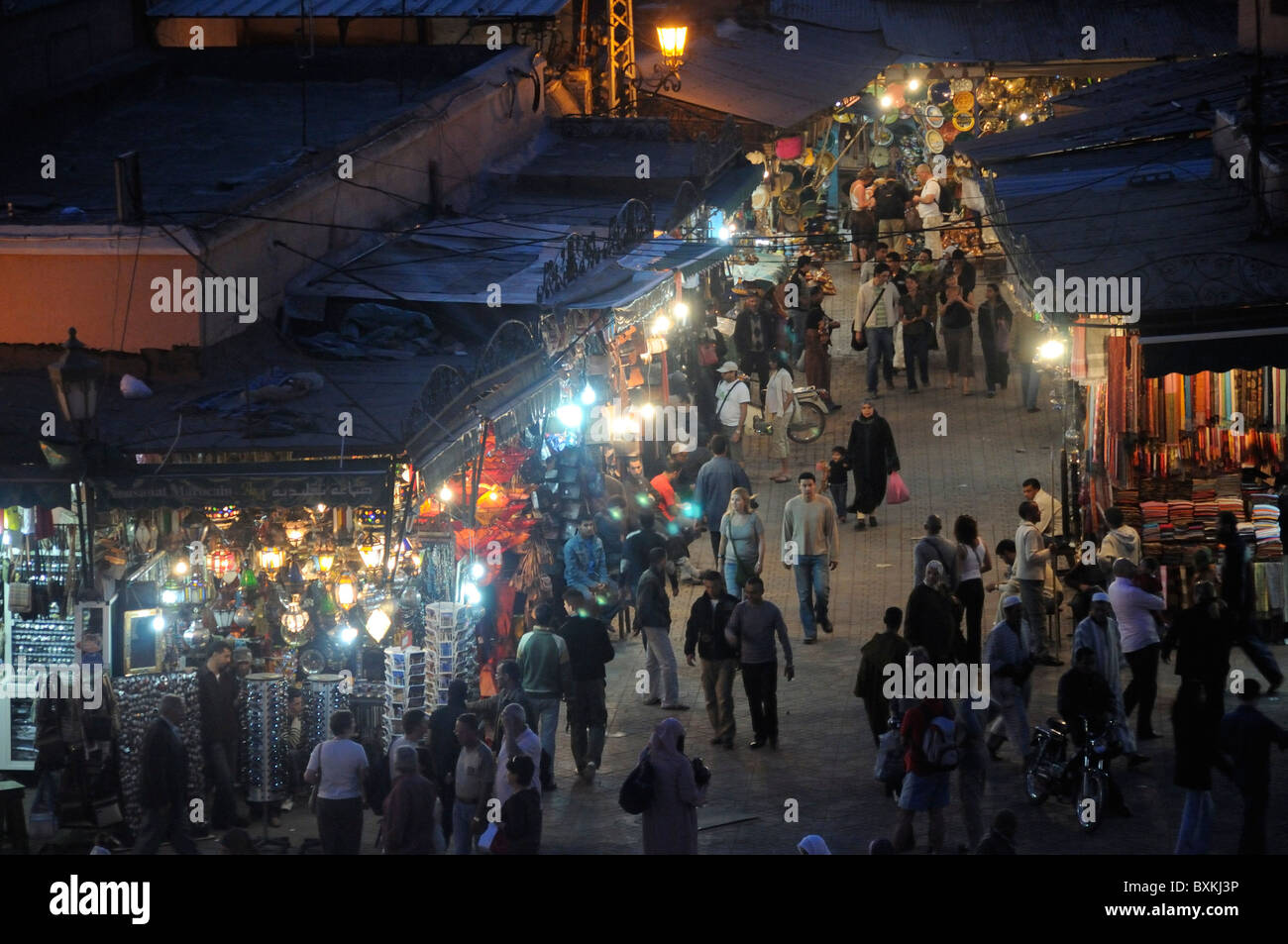 Crowds & general street scene at souk entrance, from Cafe de france at Djemaa el-Fna meeting place in Marrakech Stock Photo